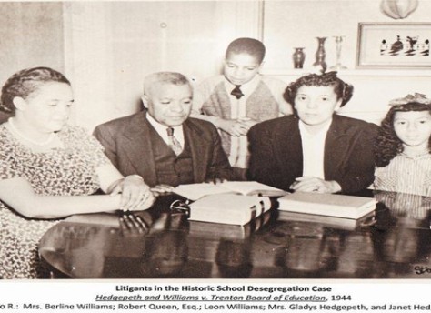 three adults and two children at a table